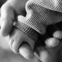Baby hand in adult hand